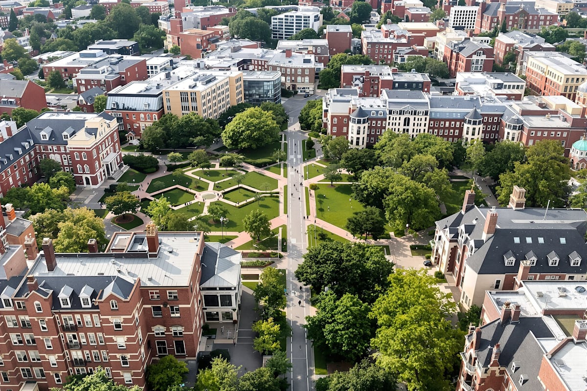 An aerial view of an urban university campus with green quadrangles between city streets.